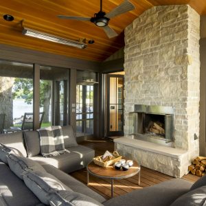 Screen porch with light stone fireplace